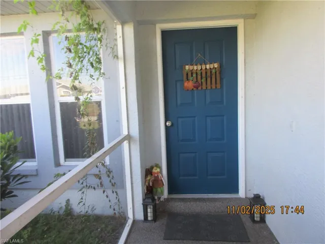 Property entrance featuring stucco siding
