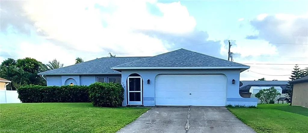 Ranch-style house with a front lawn, a shingled roof, and stucco siding