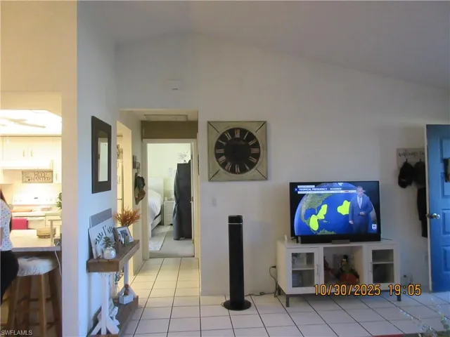 Tiled living room with lofted ceiling