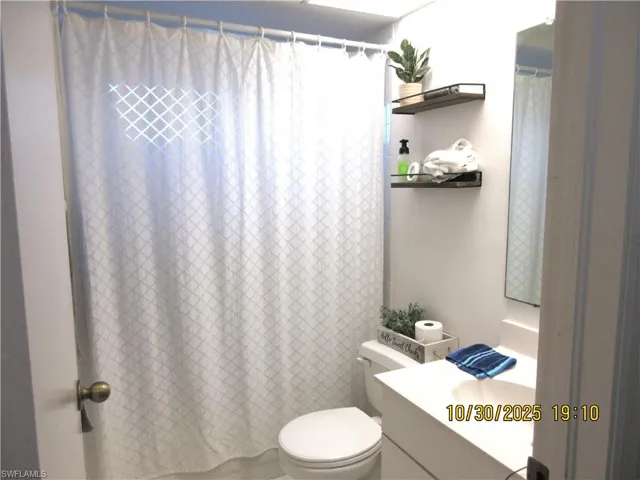Full bath featuring vanity and a shower with curtain