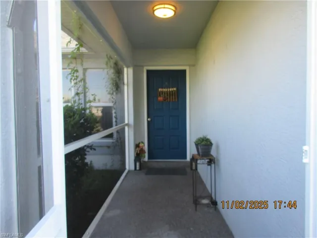 Property entrance featuring stucco siding