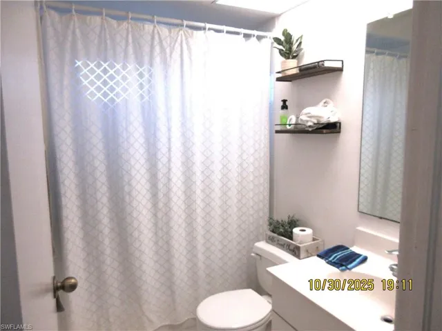 Bathroom featuring vanity and curtained shower