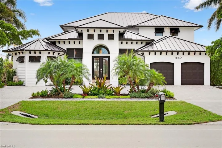 View of front of property featuring french doors, a standing seam roof, and a metal roof