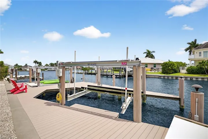 Dock with boat lift and a water view