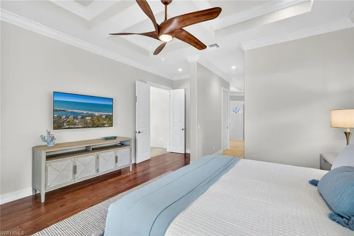 Bedroom featuring wood finished floors, recessed lighting, ornamental molding, and a ceiling fan