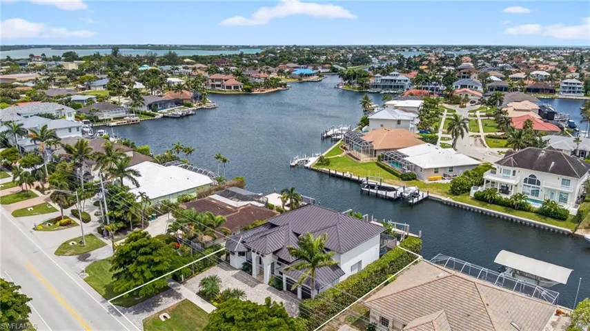 Aerial view of residential area featuring a nearby body of water