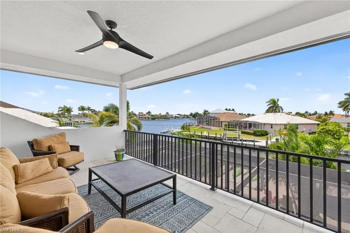 Patio / terrace with outdoor lounge area, a water view, a ceiling fan, and a residential view