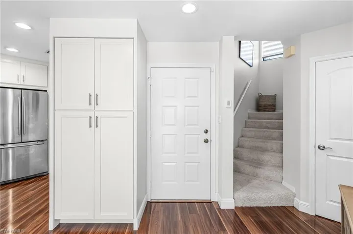 Front entry, pantry cabinetry, stairwell up to the 3rd bedroom.