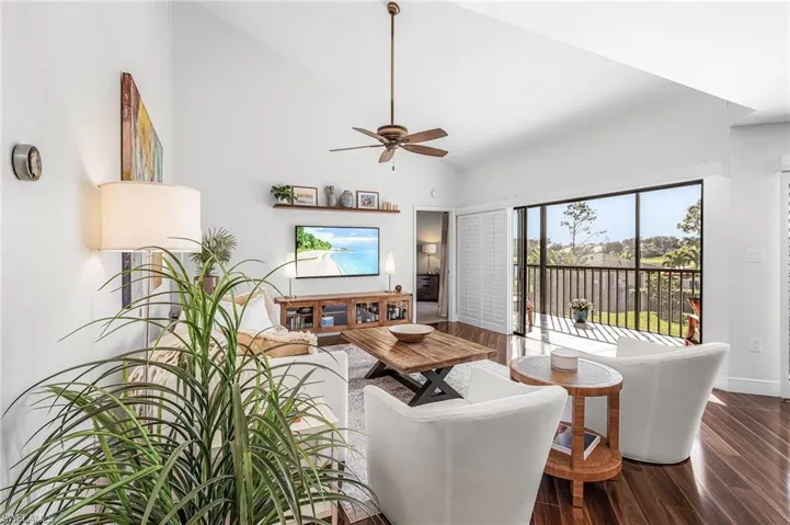 Great room has plantation shutters, vaulted ceiling, beautiful views.
