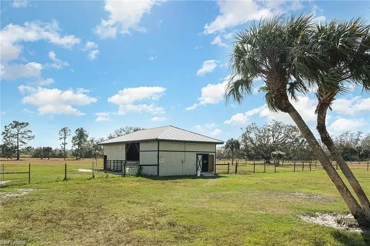 View of yard featuring a rural view and an outdoor structure