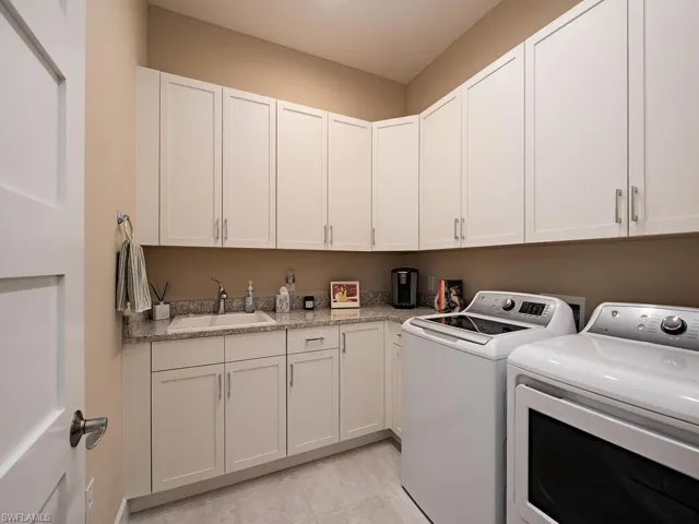 Large laundry room with lots of cabinetry.