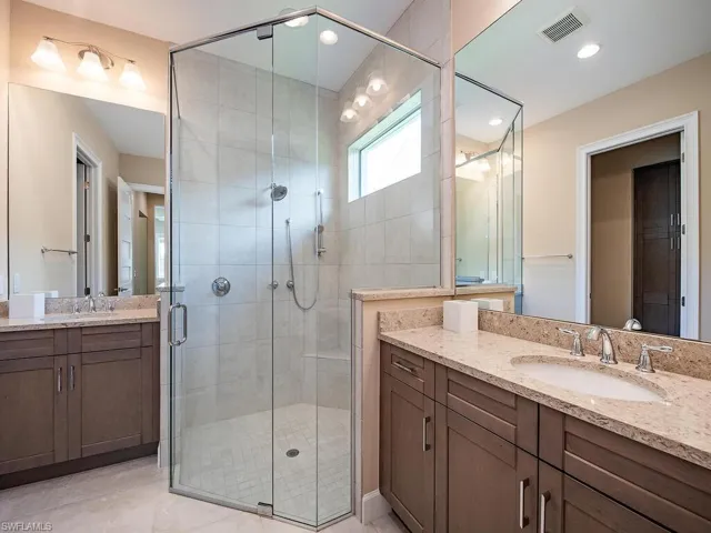 Primary bathroom with dual sinks and oversized shower.
