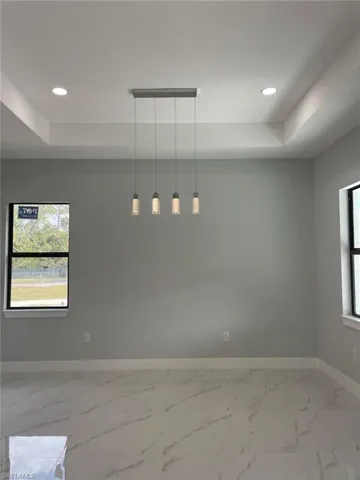 Spare room featuring a tray ceiling