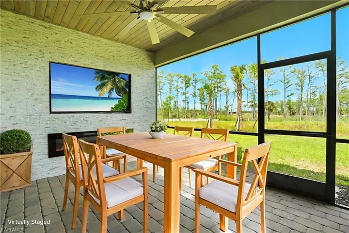 Sunroom with outdoor dining space, a ceiling fan, and healthy amount of natural light