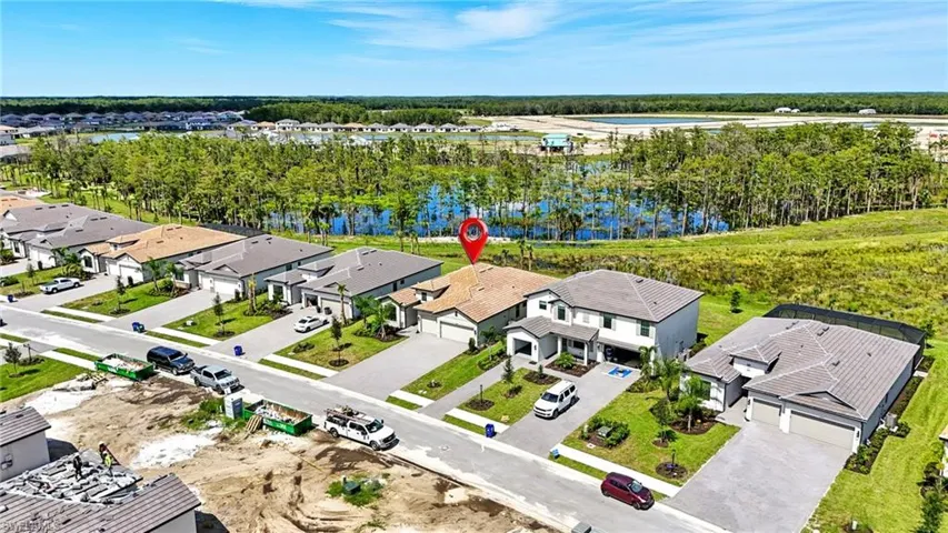 Aerial view of residential area featuring a large body of water