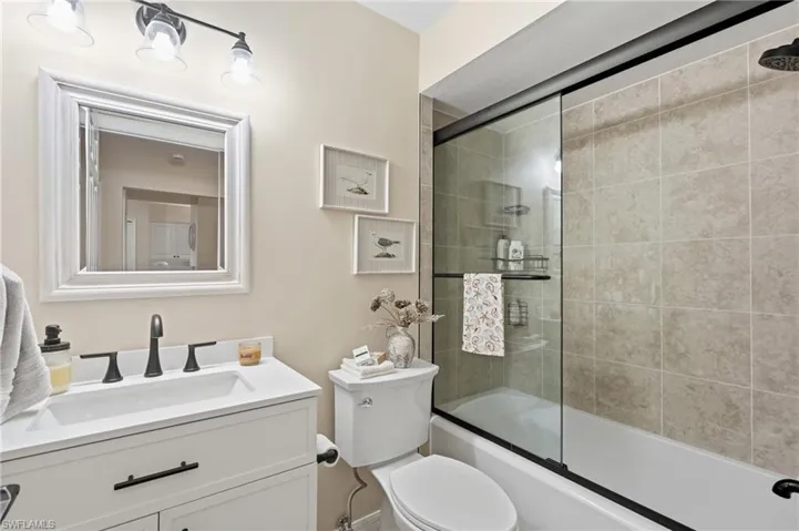 Modern vanity with an integrated sink, matte black faucet, and framed mirror