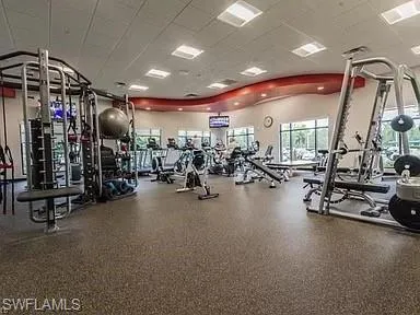 Fitness center with extensive cardio equipment, strength training machines, and rubberized flooring