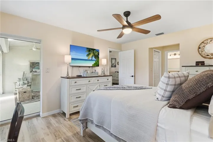 Wood-finish flooring with a ceiling fan and light fixture