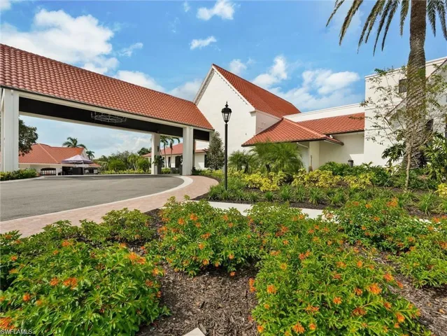 Expansive green space featuring a driving range, mature palm trees, and landscaped garden areas
