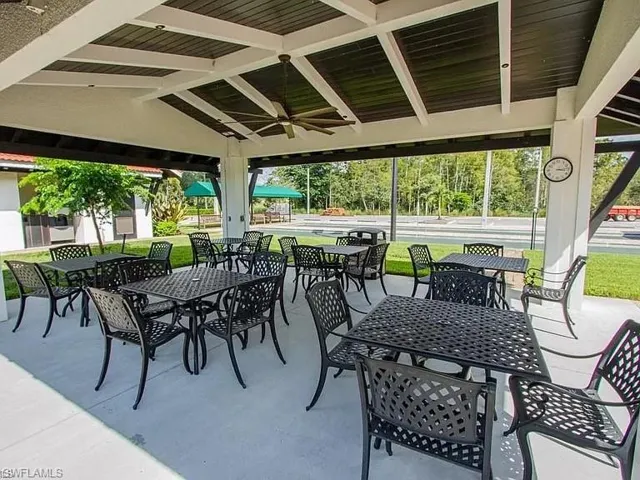 Covered outdoor patio with exposed beam ceiling, ceiling fan, and concrete flooring