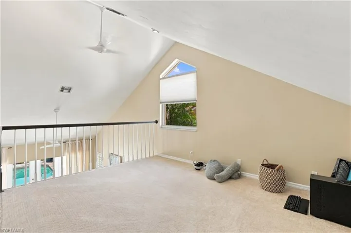 Versatile loft space overlooking the primary bedroom.