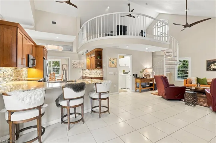 Open kitchen and living area with vaulted ceilings and loft area overlooking the family room.