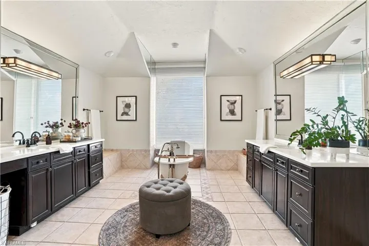 Spacious primary bath with dual vanities and abundant natural light.
