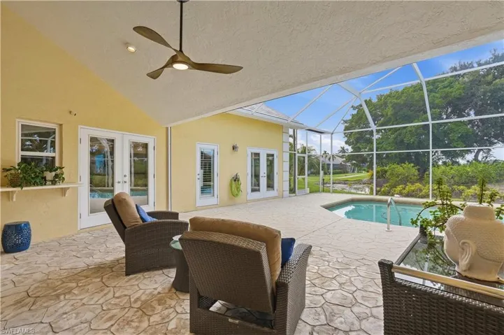 Covered lanai overlooking the private pool and screened outdoor living area.