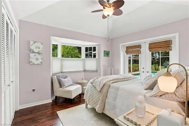 Comfortable guest bedroom with wood flooring and access to the outdoor space.