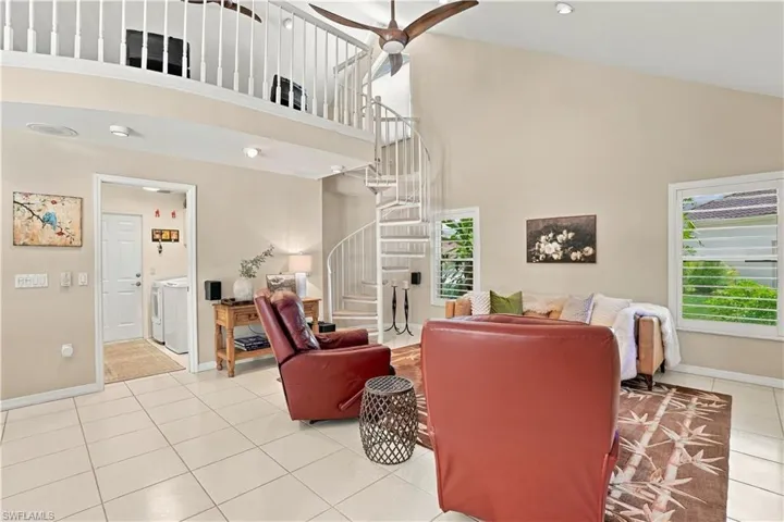 A graceful spiral staircase adds architectural interest and character to the great room.