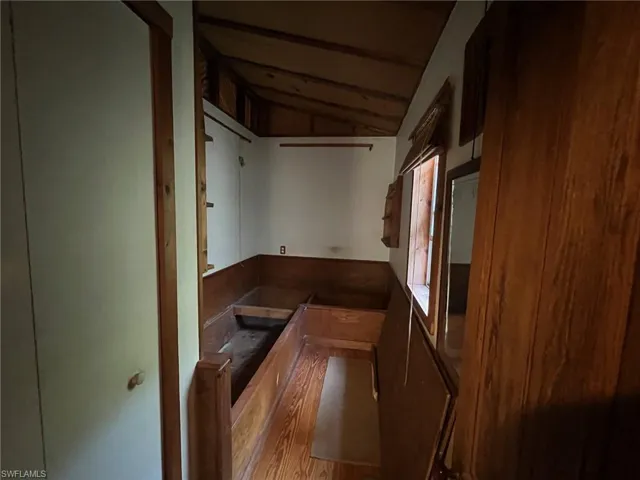Miscellaneous room featuring light hardwood / wood-style flooring and lofted ceiling