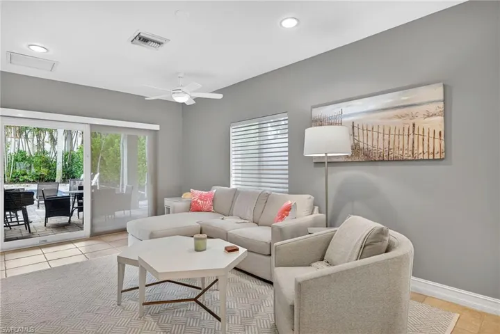 Living area featuring light tile patterned floors, ceiling fan, and recessed lighting
