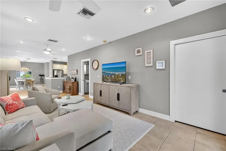 Living room with recessed lighting, ceiling fan, and light tile patterned floors