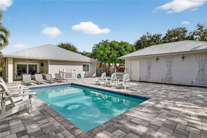 View of swimming pool with a patio area and a ceiling fan