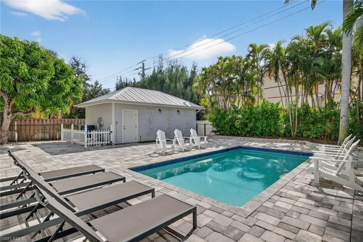 View of swimming pool featuring a patio area and an outdoor structure