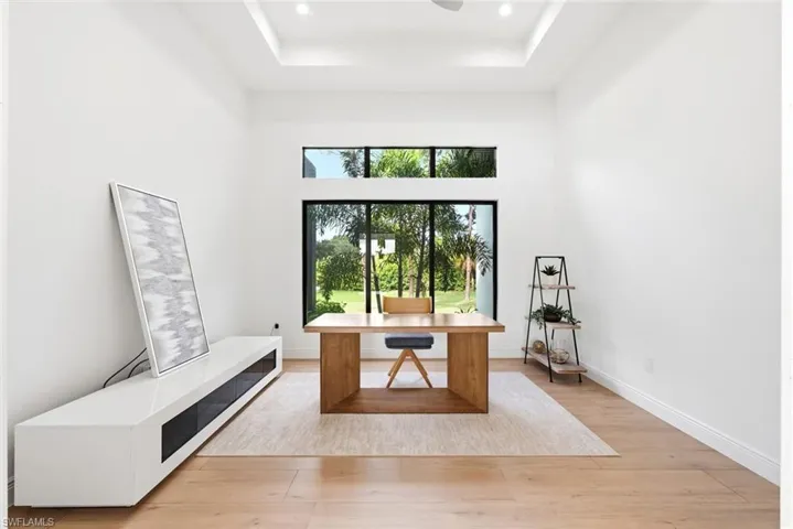 Recessed lighting, tray ceiling, full-height windows, transom windows, wood-finish flooring
