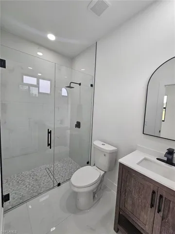 Bathroom featuring vanity and a stall shower