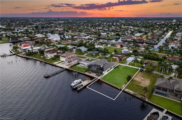 Aerial view at dusk featuring a water view
