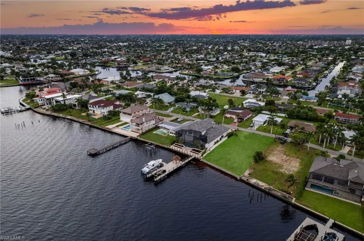 Aerial view at dusk featuring a water view