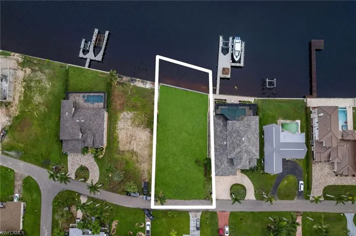 Birds eye view of property with a water view