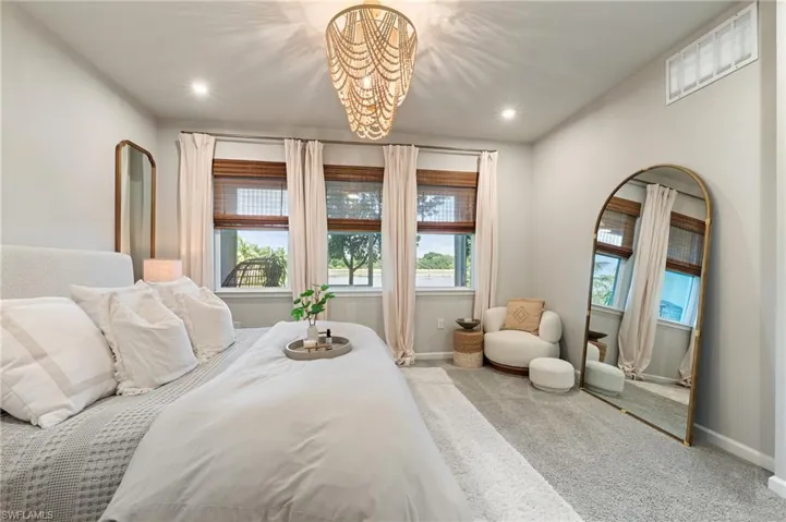 Bedroom with carpet, a chandelier, and recessed lighting