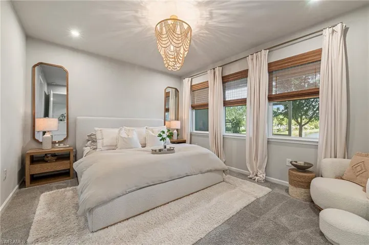 Bedroom with carpet floors, recessed lighting, and a chandelier