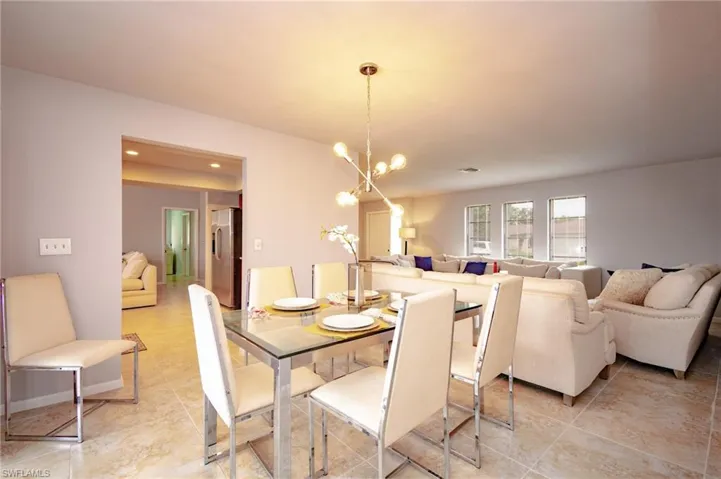 Open-concept living area featuring light-toned tile flooring throughout