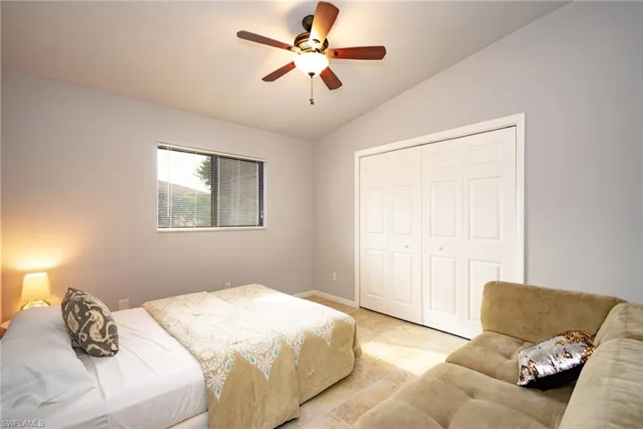 Vaulted ceiling with a ceiling fan and light fixture