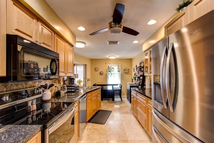 Updated kitchen, granite counters, newer upgraded stainless steel appliances lots of cabinets.  Opens to dining room with pool view -- perfect for those who love to cook and entertain