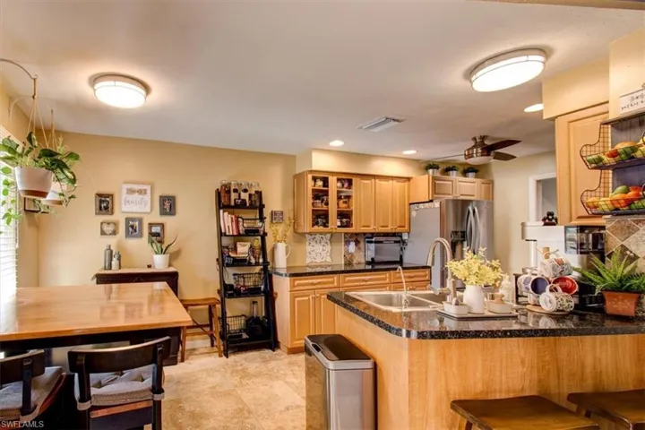 Beautiful updated kitchen with eat-in area and breakfast bar -- Stainless steel appliances, granite counters, tile floors