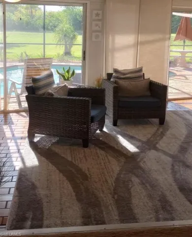 sitting area in the bright dining room next to the pool