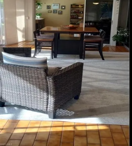 Dining area with view of pool, kitchen and living room