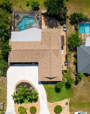 Circular Driveway with mature beautiful landscaping from front to backyard.