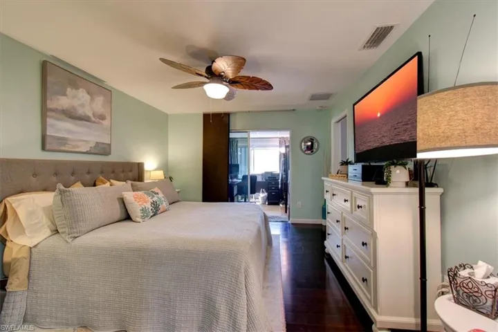 Master bedroom to lanai - beautiful wood floors & paddle fan